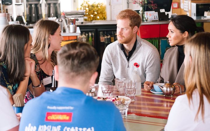 Prince Harry and Meghan, the Duchess of Sussex, discuss with Jazz Thornton and General Mora, founders of Voices of Hope at Maranui Cafe in Wellington.