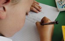 child writing at school