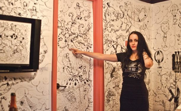 Molly Crabapple with the work she created during her Week in Hell.