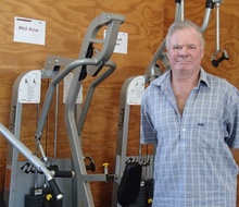 Nigel Bass standing next to the weights machines in the gym.