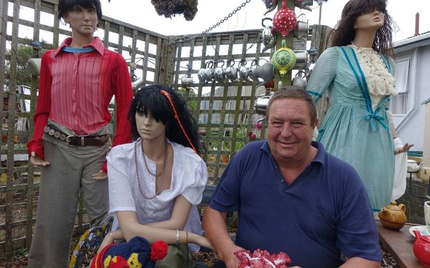 Graham Renwick with his mannequins among his teapot collection.