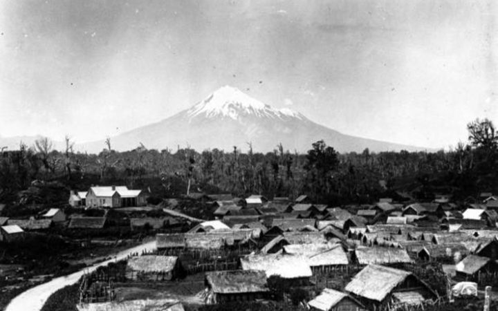Parihaka Pa, circa 1900, with Mount Taranaki - taken by an unidentified photographer. 
