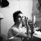 Rowena Jackson in costume applying make up prior to a performance photographed July by Morrie Hill from Alexander Turnbull Library Collections