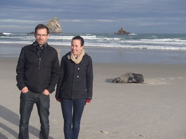 Jon Waters and catherine Collins with a New Zealand sealion at Sandfly Bay on the Otago peninsula
