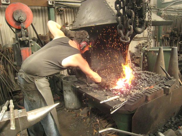 Blacksmith Kim Nielsen placing jack hammer bits into the forge