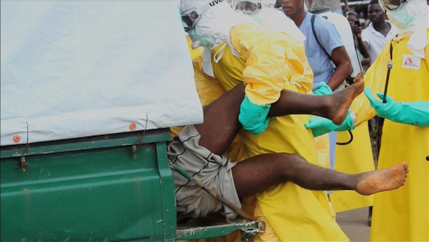 An Ebola patient being forced into an ambulance