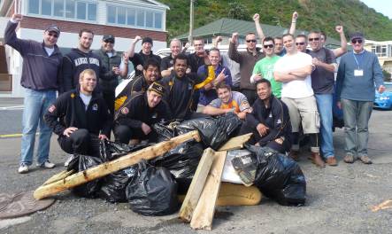 Wellington Lions Rugby team players and Ricoh NZ staff with the rubbish they collected during a beach clean up at Island Bay