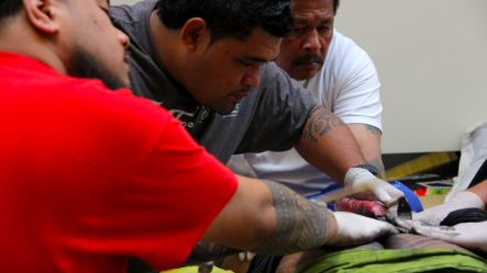 The art of traditional Samoan tattoo tatau in action performed by Master Paul Junior Sulu ape image Tala Suailua