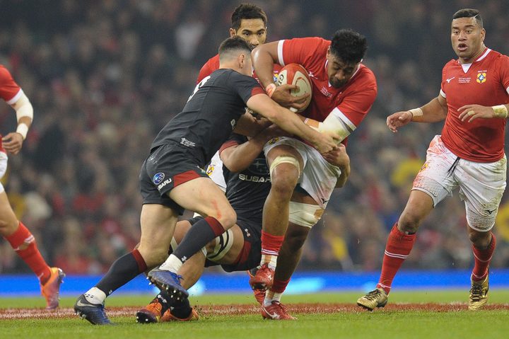 Tonga's Dan Faleafa is tackled by Tomos Williams during the 74-24 defeat in Cardiff.
