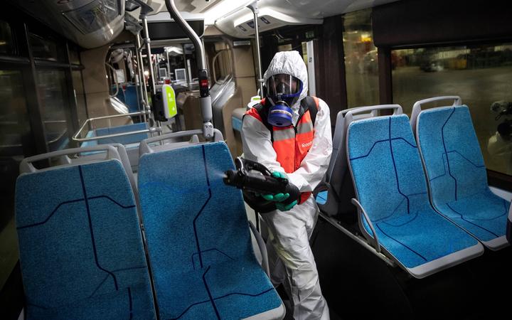 A cleaning worker disinfects a bus in  Paris, 5 May 2020.
