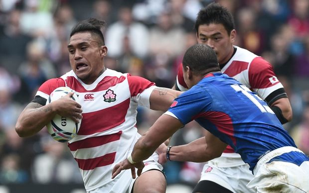 Japan centre Male Sau holds off Samoa's centre Paul Perez during their Rugby World Cup pool match.
