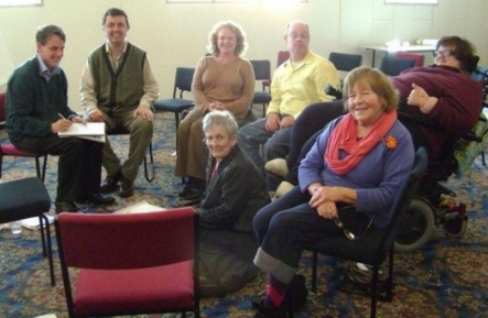 Welfare Justice member, Wendi Wicks (seated on floor), during the rounds of consultation with members of the disability community.