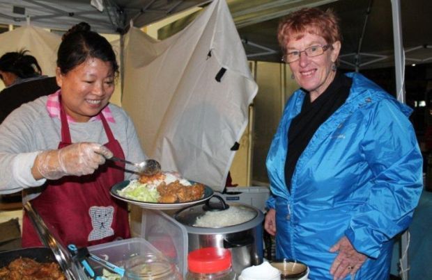 Khaing Khaing serves balachau prawn paste to WISE Co ordinator Heather Tanguay
