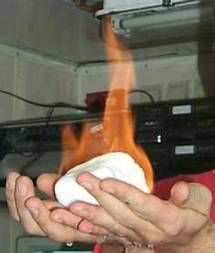 A block of frozen methane hydrate that has been set alight and is burning