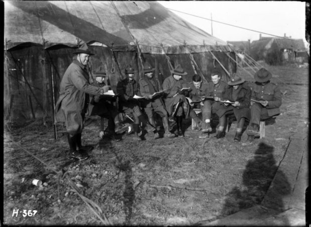 The Kiwis learning their parts for the pantomime The Forty Thieves to be produced on Boxing Day Photograph taken near Dickebusch Belgium December by Henry Armytage Sanders ATL