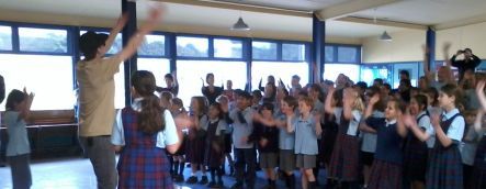 Science rapper Tom Mcfadden and a groupl of primary school pupils in action