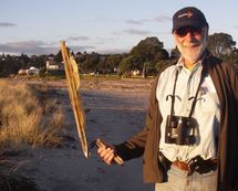 Julian Pettifer at maketu with a piece of container debris from the Rena 
